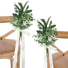 two vases filled with flowers sitting on top of a wooden chair next to each other