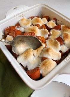 a casserole dish with marshmallows and sauce