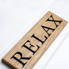 a wooden sign that says relax on it