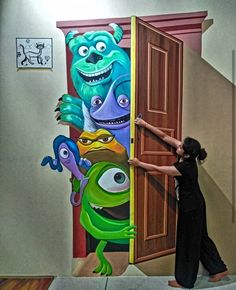 a woman standing in front of a wall with monsters painted on it and an open door