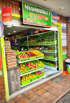 a store front filled with lots of fresh fruit and veggies on the shelves