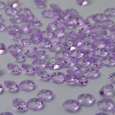 many purple diamonds on a white surface