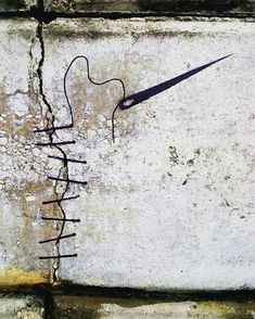 a piece of art that has been drawn on the side of a building with wires attached to it