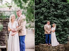 a man and woman standing next to each other in front of a stone wall with greenery