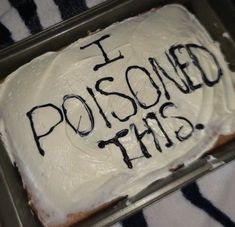 a frosted cake with the words i poised this on it in black writing