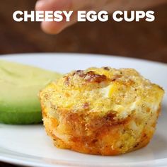 a close up of a muffin on a plate with a cucumber in the background