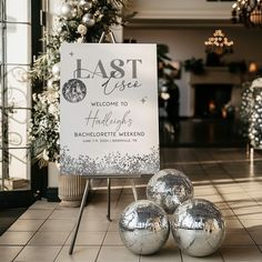 three shiny disco balls sitting in front of a sign that says fast rise welcome to holidays