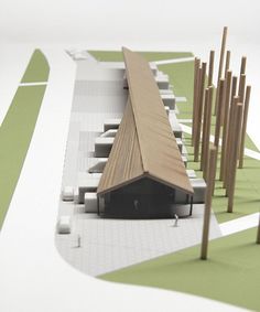 an architectural model of a building with wooden posts