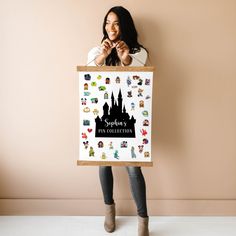 a woman is holding up a poster with disney's pin collection stickers on it