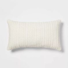 a white pillow sitting on top of a white wall