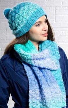 a woman wearing a blue hat and scarf