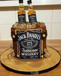 a cake made to look like two bottles of jack daniels whiskey on top of ice