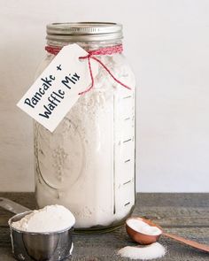 a mason jar filled with white powder next to a measuring spoon