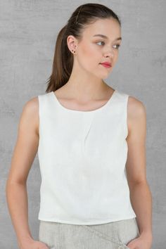 100% PURE LINEN BLOUSE Blouse made from optical white linen fabric. Simple, yet elegant, versatile garment, especially, looks great with our linen skirt and trousers. This subtle design blouse will be easy to match with any skirt, especially it will look great with our linen skirt. https://www.etsy.com/listing/510816562/linen-women-skirt-pure-linen-long-skirt?ref=shop_home_active_88 *Blouse without sleeves. *It has a rounded neckline. *Decorative detail - pleat in front. *Fitted at the back. *Fa Linen Workwear Top, Solid Linen Top For Work, Solid Linen Tops For Work, Elegant Flax Linen Dress, Chic White Linen Blouse, Elegant Fitted Linen Blouse, Simple White Linen Top, Elegant Linen Blouse For Work, White Sleeveless Linen Blouse