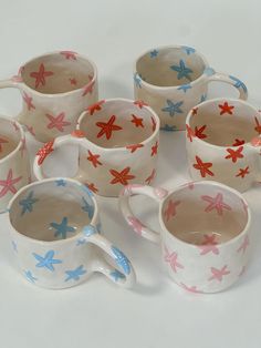 six coffee cups with starfish designs on them