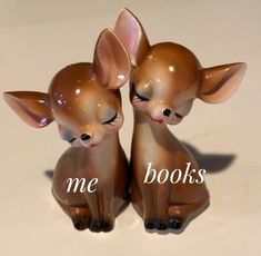 two little deer figurines sitting next to each other with the words me books on them