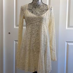 New Without Tags Free People Ivory L/S Fir N Flare Dress Size: S 55% Nylon, 44% Cotton & 1% Spandex Fully Lined Bust: 37" Sleeve Length:25" W Flare Length: 31" Side Zip With Small Metal Back Buttons Spring Long Sleeve Stretch Lace Dress, Spring Stretch Lace Dress With Long Sleeves, Beige Lace Mini Dress With Long Sleeves, Beige Long Sleeve Lace Mini Dress, Beige Lace Long Sleeve Mini Dress, Cream Long Sleeve Stretch Dress, Cream Fitted Lace Dress With V-neck, Cream Stretch Mini Dress, Cream Flowy Lace Mini Dress