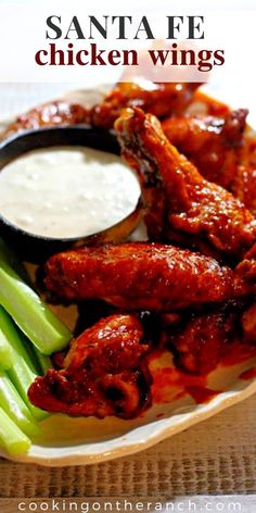 chicken wings and celery on a plate with ranch dressing in the background, text overlay reads santa fe chicken wings