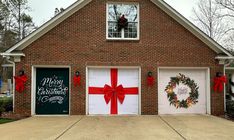 two garage doors decorated with christmas wreaths and presents for the front of their home