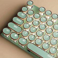 a close up of a computer keyboard with lots of knobs on the back side