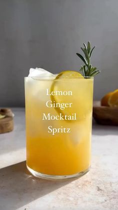 lemon ginger mocko cocktail with rosemary garnish in a glass on a table