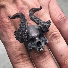 This awesome horned demon skull ring is made of solid 316L surgical stainless steel. The demon skull ring has a unique dark antiqued satin finish and approximately measures 40mm wide/long at the front center down to 8mm wide at the back of the band. This horned demon skull ring is available in sizes 8, 9, 10, 11, 12, and 13. A gift box is included with the purchase. SKU: FFJ-SSR-589 Black Skull Ring, Skeleton Ring, Horn Ring, Mens Stainless Steel Rings, Biker Rings, Vintage Skull, Gothic Rings, Punk Jewelry, Black Skulls