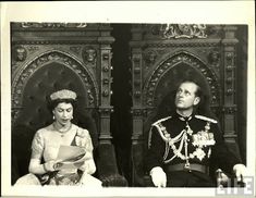 an old black and white photo of a man in uniform sitting next to a woman