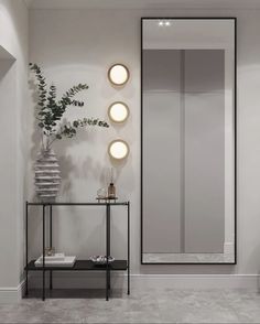 a modern bathroom with three round lights on the wall