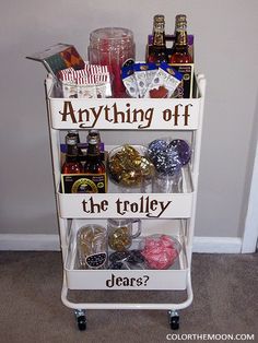 a white cart filled with lots of different types of drinks and condiments on top of it