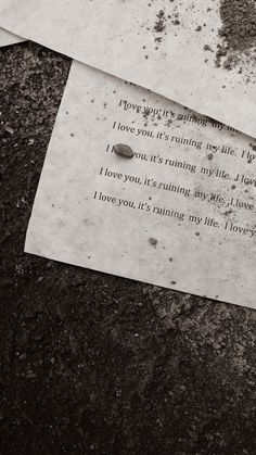 two pieces of paper that have been left on the ground with some writing on them