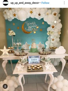 a welcome baby sign and dessert table with balloons in the shape of stars on it