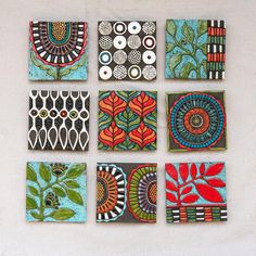 nine handmade tiles with different designs on them