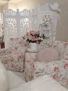 a living room filled with furniture and flowers