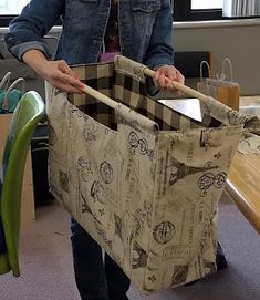 a woman is holding a large bag in her hands