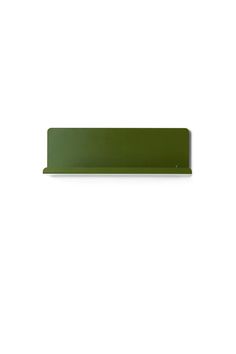 a green shelf sitting on top of a white wall