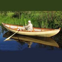 a man is sitting in a canoe on the water