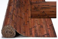 a roll of wood flooring sitting on top of a wooden floor next to a roll of rope