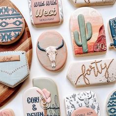 many decorated cookies are displayed on a table