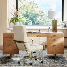 a white chair sitting in front of a wooden desk