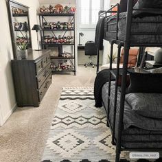 a bedroom with two bunk beds and a rug on the floor