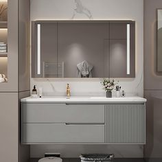 a bathroom with a sink, mirror and lights on the wall above it's counter