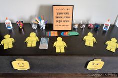 a table with legos made out of paper and markers on it, including an orange sign