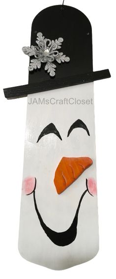 a white bag with a carrot sticking out of it's mouth and snowman hat on top