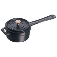 a black cast iron pot with a handle and knob on the side, sitting against a white background