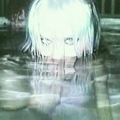 a girl with white hair is in the water