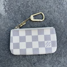 This Louis Vuitton Key Pouch Is A Stylish Accessory For Any Woman. The Damier Azur Color Gives It A Trendy Look, While The Canvas Material And Zipper Closure Ensure Durability. The Pouch Is Perfect For Carrying Your Credit Cards, Keys, And Coins, Making It A Versatile Addition To Your Collection. The Compact Size And Key Chain Feature Make It Easy To Attach To Your Bag Or Key Ring For Easy Access. Add A Touch Of Luxury To Your Daily Routine With This Louis Vuitton Key Pouch. Things To Note: * Discontinued Style * Feeling Of Use * Tarnishing To Hardware * Interior Has Coin Residue * Dirt Along Zipper * Corner Rubbing *Small Spot On Bottoms Corner (Did Not Attempt To Clean) * 100% Aut Small Keychain Wallet, Fake Louis Vuitton Key Pouch, Lv Keychain Pouch, Louis Vuitton Key Holder With Keys, Louis Vuitton Key Pouch With Keys, Lv Key Pouch, Louis Vuitton Key Pouch, Louis Vuttion Key Pouch, Key Pouch