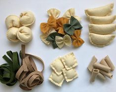 several different types of felt flowers on a white surface