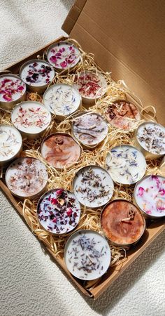 a box filled with lots of different types of desserts on top of a table