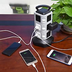 an electronic device is plugged into the charger on a table next to two cell phones