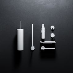 an assortment of bathroom accessories on a black surface